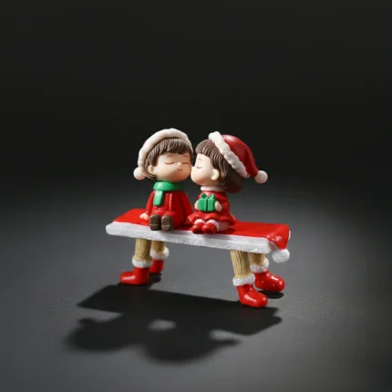 Christmas couple miniature sitting on a decorative bench