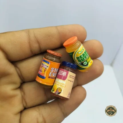 A detailed miniature health drink bottle product with a colorful, authentic-looking label, designed for a dollhouse kitchen setting.
