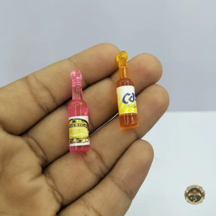 A miniature juice bottle product with a yellow label, designed to look like an Indian beverage for dollhouse grocery scenes.