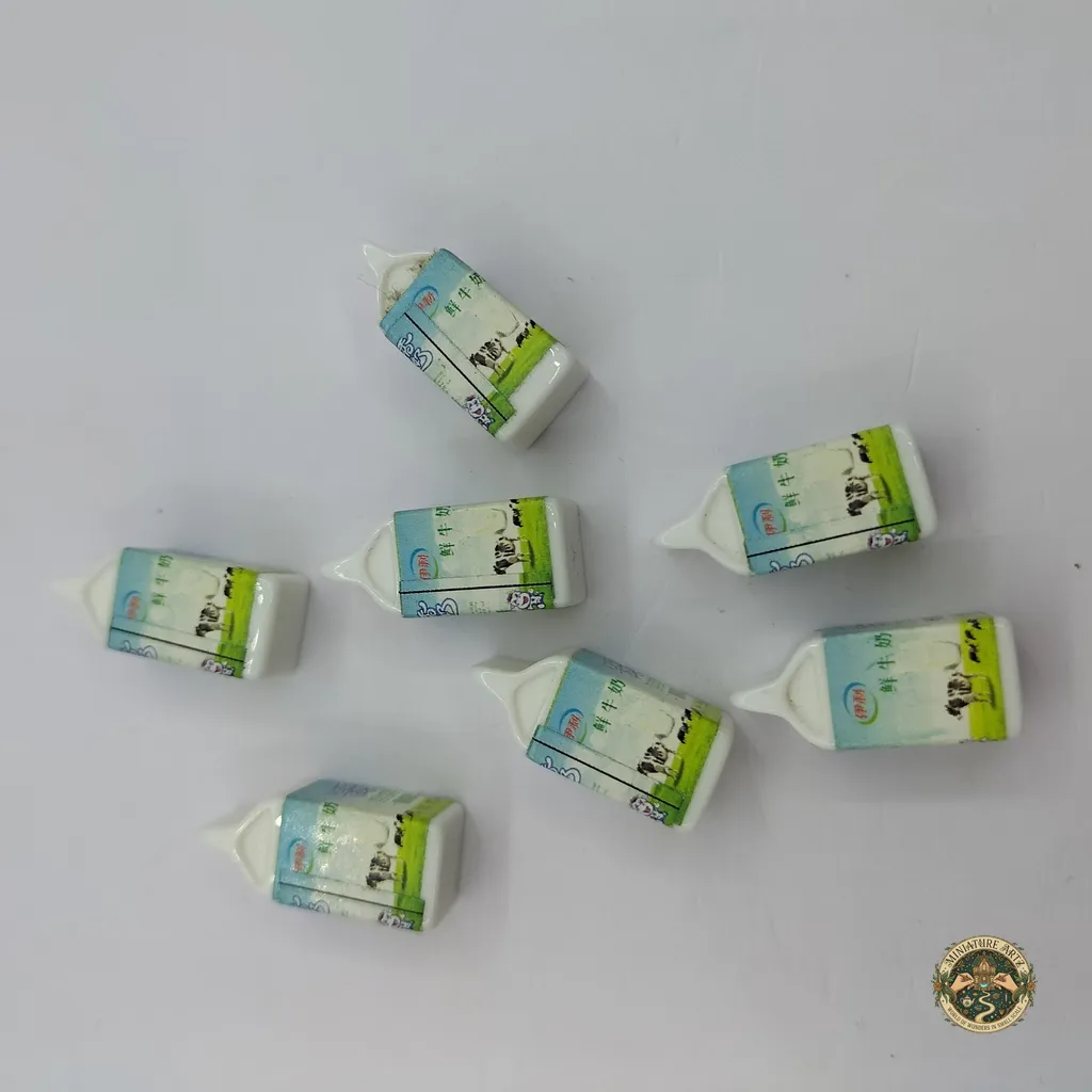 milk-packet-1 A hyper-realistic miniature milk packet product scaled for dollhouse kitchens, featuring detailed graphics and a sealed carton top.