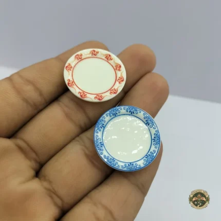 A set of four ceramic dollhouse miniature plates product, each featuring intricate blue floral patterns on a white surface.