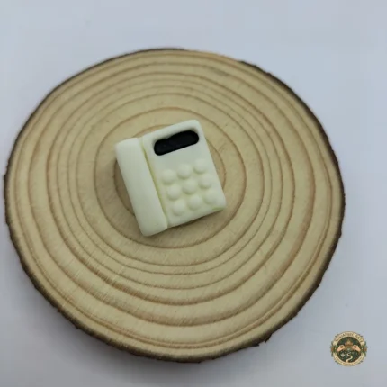 A detailed miniature retro telephone product in a glossy black finish, featuring a classic rotary dial and a coiled cord handset.