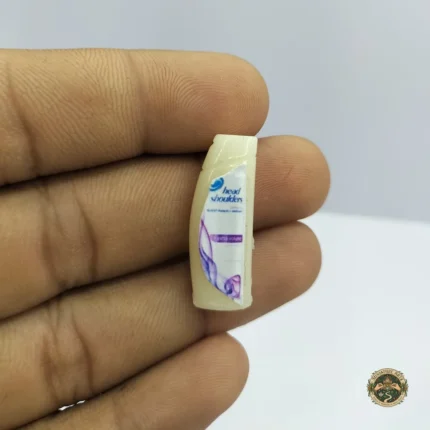 A realistic dollhouse shampoo bottle product with a detailed label and glossy finish, shown in a 1:12 scale for miniature scenes.
