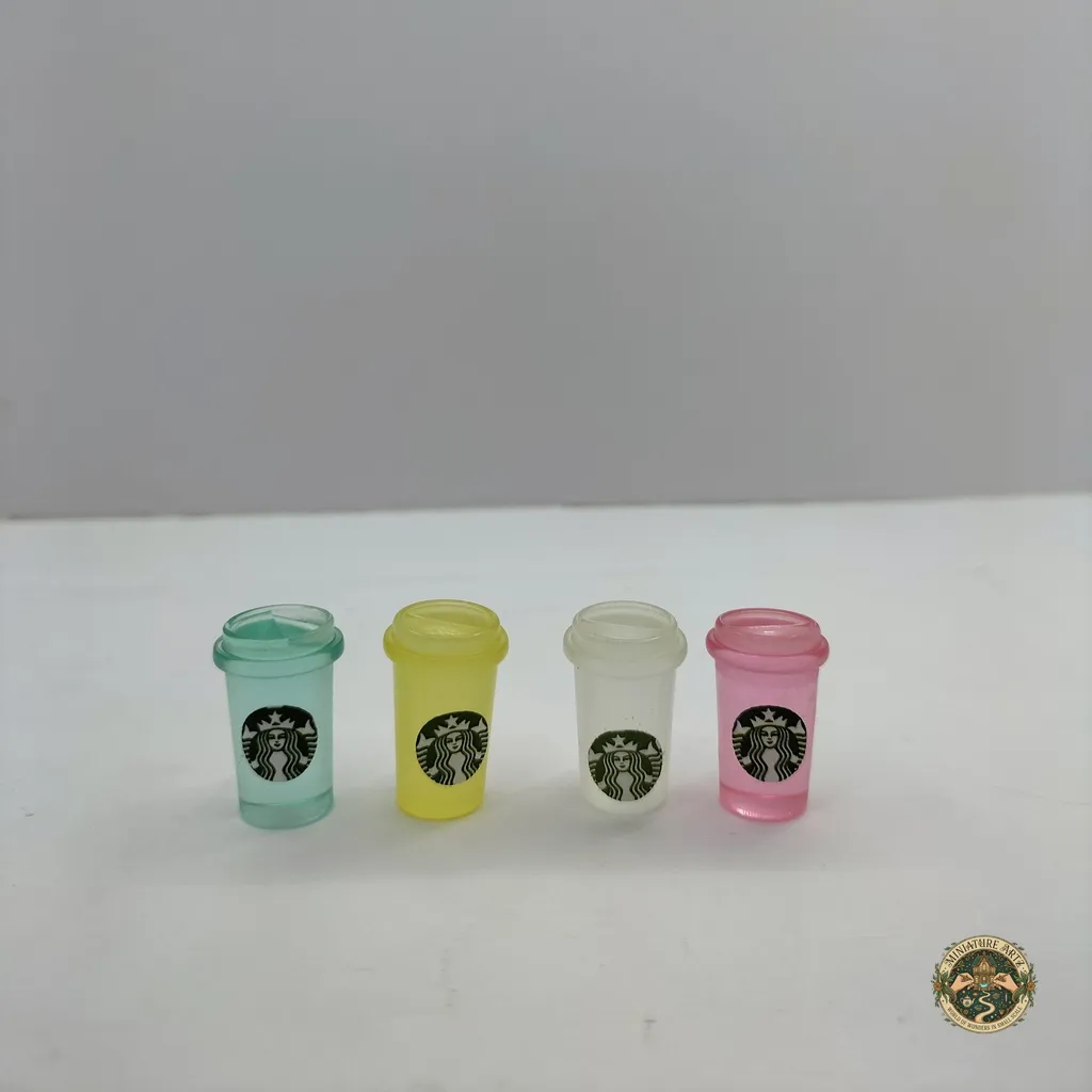 starbucks-juice-bottles-1 A realistic miniature juice bottle product with a vibrant orange liquid and detailed label, for 1:12 scale dollhouse kitchen displays.