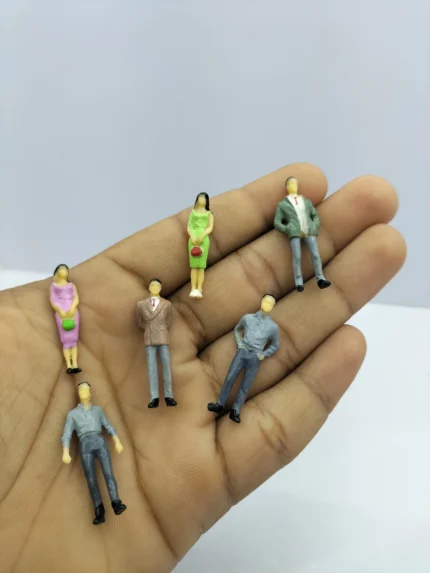 A detailed human miniature figurine product in a neutral pose, showing the folds in its clothing and proportions.