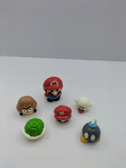 A complete Mario theme miniature set product displaying colorful, detailed figurines of characters and items on a white background.