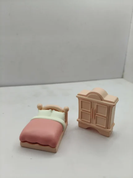 A complete miniature pink bedroom furniture set product arranged in a diorama, showcasing the detailed wooden bed, dresser, and wardrobe.