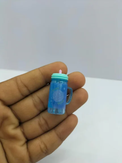 A realistic miniature mineral water bottle product with a clear body and a detailed blue and white label, designed for dollhouse dioramas.