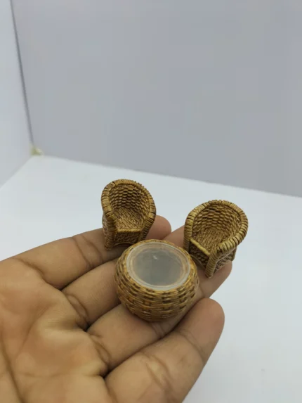 A miniature wicker sofa set product, including a sofa, two chairs, and a coffee table, all with white cushions for a dollhouse.