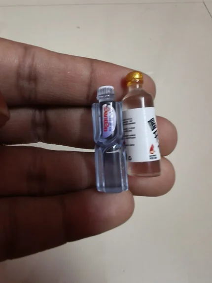 Miniature drink set product with tiny glasses and bottles, perfect for a realistic dollhouse scene.
