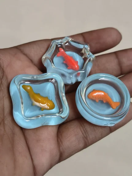 Miniature fish tank product, beautifully crafted with tiny fish and plants, ideal for dollhouse scenes.
