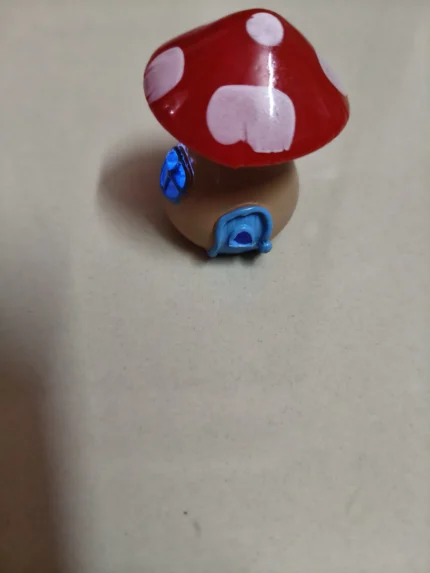 Miniature mushroom house product, enchanting and lighted, with intricate details and a warm LED glow.