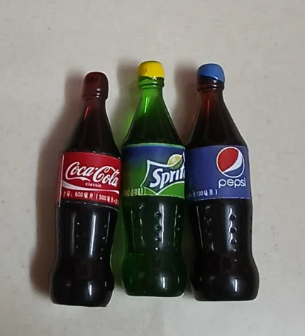 Vibrant set of miniature soft drink bottles, detailed and realistic product for dollhouses and dioramas.