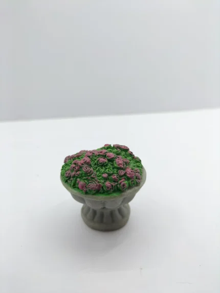 A miniature garden flower pot product with a terracotta finish, shown against a background to highlight its small scale and texture.