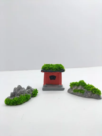 A complete miniature garden kit product displayed on a white background, showing tiny tools, plants, a bench, and fencing.