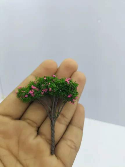 A highly detailed miniature tree for diorama product, showcasing realistic green foliage and a textured brown trunk on a stable base.