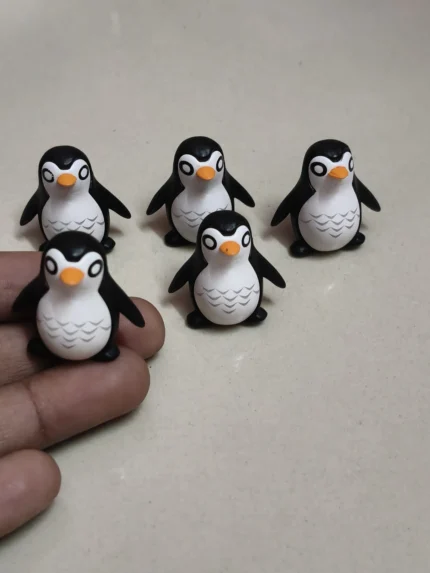 Detailed, hand-painted penguin miniature figurine, perfect for collectors and dioramas. High-quality product.