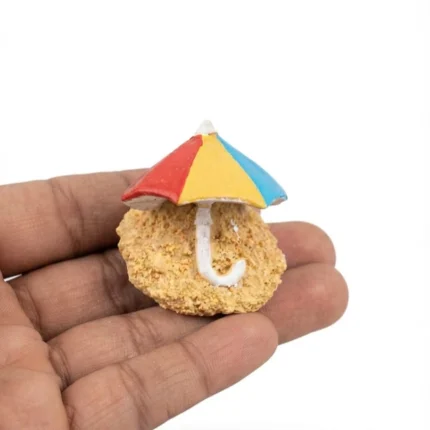 Miniature beach umbrella product with striped canopy and sandy base, ideal for dollhouse and diorama displays.