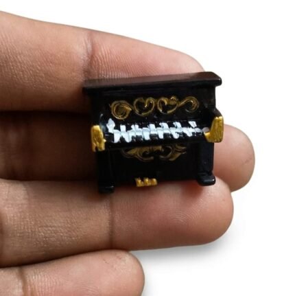 Detailed black and gold ornate upright piano miniature figurine product for collectors and dollhouse enthusiasts.