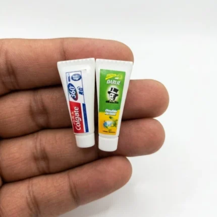 Miniature Colgate and Darlie toothpaste tubes product, ideal for dollhouse scenes or travel.