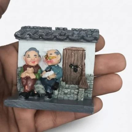 Resin product depicting an elderly couple at a traditional Chinese courtyard house miniature.