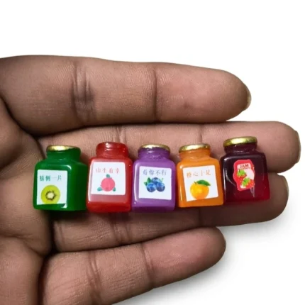 Miniature fruit jam jar figurine product, random design, ideal for dollhouse scenes or tiny food displays.