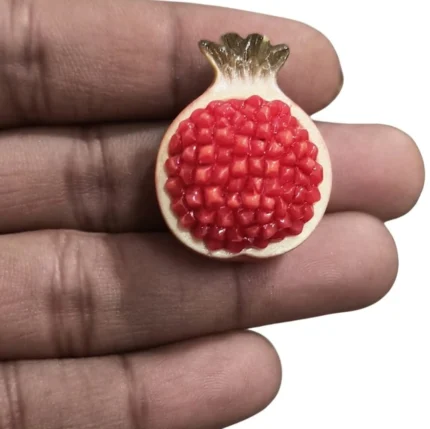 Detailed halved pomegranate miniature figurine, a resin product for dollhouse kitchens or food displays.