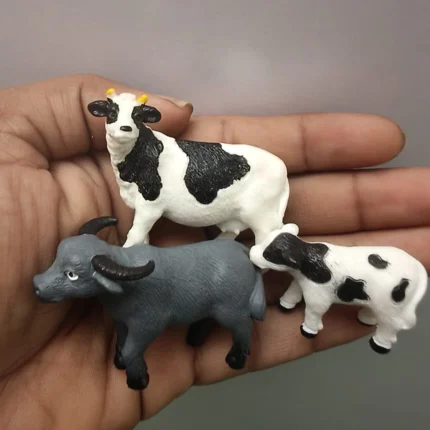 Product image of a set of three miniature animal figurines: Holstein cow, calf, and water buffalo.