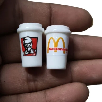 Close-up of KFC and McDonald's miniature cup set, showcasing intricate branding and realistic product design.