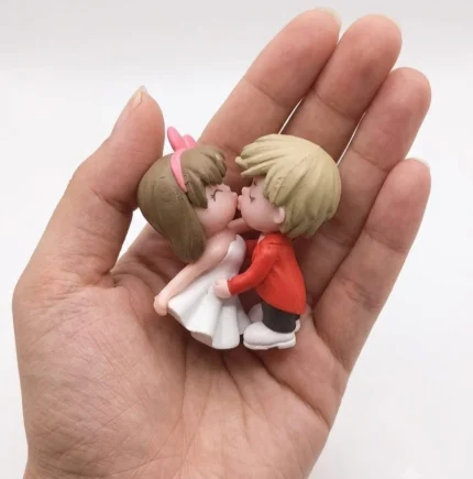 Chibi style kissing couple miniature figurine product, hand-painted, perfect for any display.