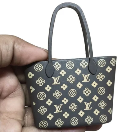 Meticulously crafted Louis Vuitton Monogram miniature tote bag figurine, iconic pattern. A charming product.