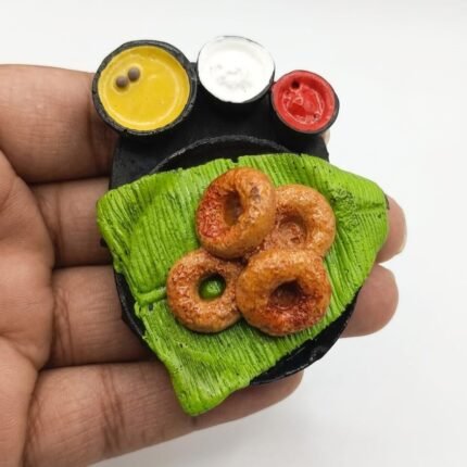 This unique medu vada miniature magnet product features a South Indian breakfast with sambar and chutney.