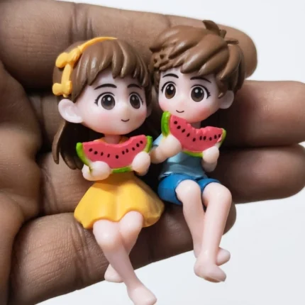 Charming miniature couple figurine product, two small figures happily eating watermelon slices.