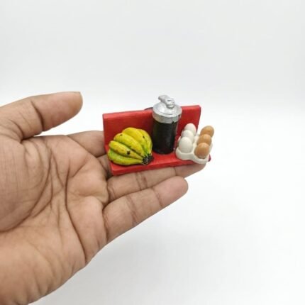 Miniature kitchen tray set with realistic bananas, eggs, and canister. Perfect product for dollhouse collectors.