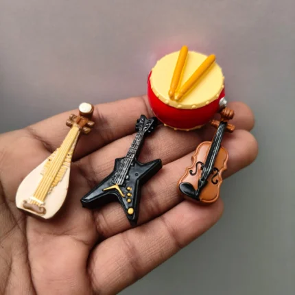 Detailed product image of four miniature musical instruments, ideal for dollhouse scenes or collectors.