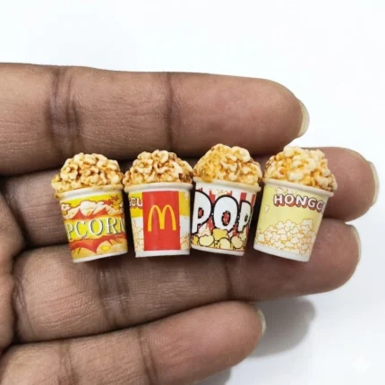 Detailed miniature popcorn bucket product. Perfect for dollhouse, diorama, or tiny food displays.