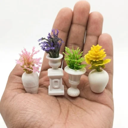 A realistic miniature potted plant in a white vase, a perfect dollhouse decor product for enhancing tiny interiors.