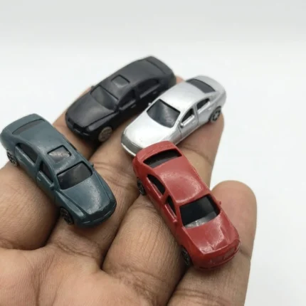 A vibrant miniature sedan car product in a random color, perfect for collectors, diorama builders, and display.