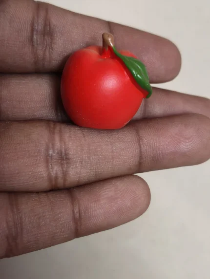 Detailed miniature red apple fruit figurine with vibrant color and realistic texture, ideal dollhouse product.