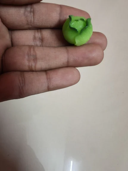 Realistic miniature green capsicum product for dollhouse scenes, diorama food, or miniature garden displays.