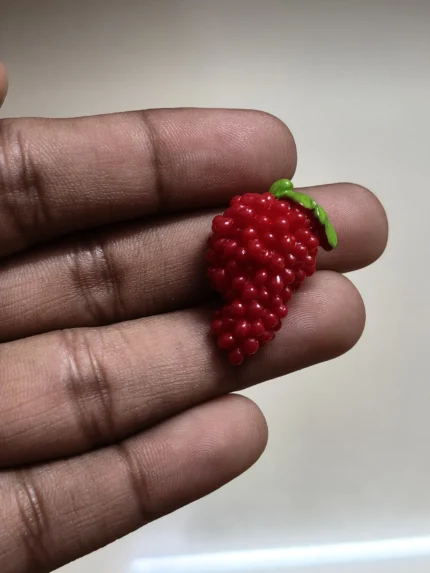 Highly detailed miniature raspberry fruit figurine product for dollhouse kitchens or miniature food displays.