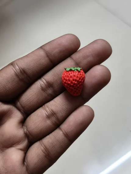 Detailed, handcrafted miniature strawberry fruit figurine product for dollhouse displays and tiny food collections.
