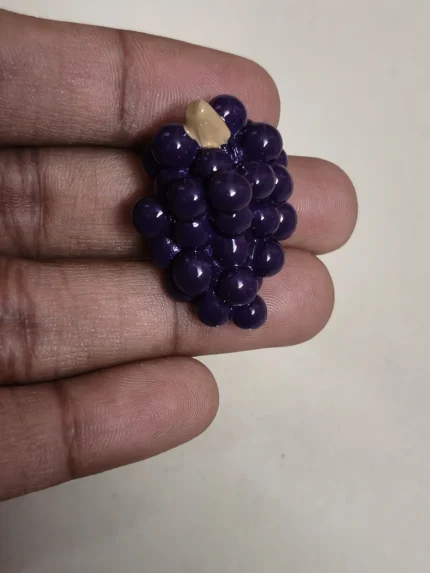 Detailed miniature purple grapes cluster figurine, a lifelike product for dollhouse kitchens and dioramas.