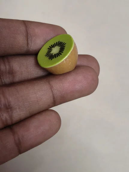 Highly detailed miniature halved kiwi fruit figurine product for dollhouse kitchens or tiny food.