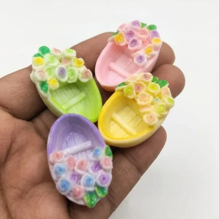 Pastel floral rowboat resin flat-back embellishment product for dollhouse or craft projects.