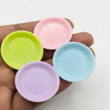 A collection of colorful miniature pastel plates, made of plastic, are shown as a dollhouse accessory product.