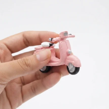 Pink vintage scooter miniature figurine product, highly detailed, perfect for retro display or collection.