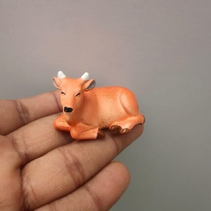 Charming hand-painted resting cow miniature animal figurine product, perfect for farm dioramas.