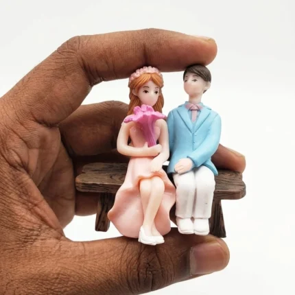 Romantic miniature couple on a bench resin figurine product, perfect for miniature scenes or collections.