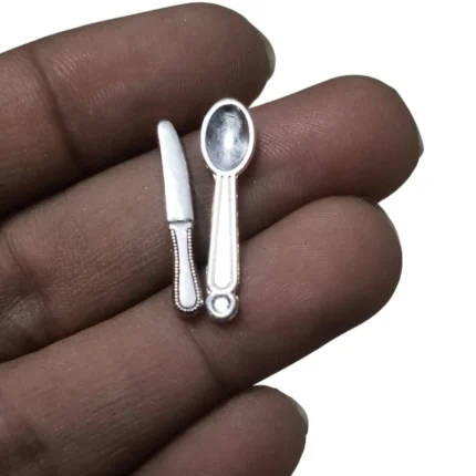 Finely detailed silver miniature knife and spoon cutlery set, an exquisite product for dollhouse dining.
